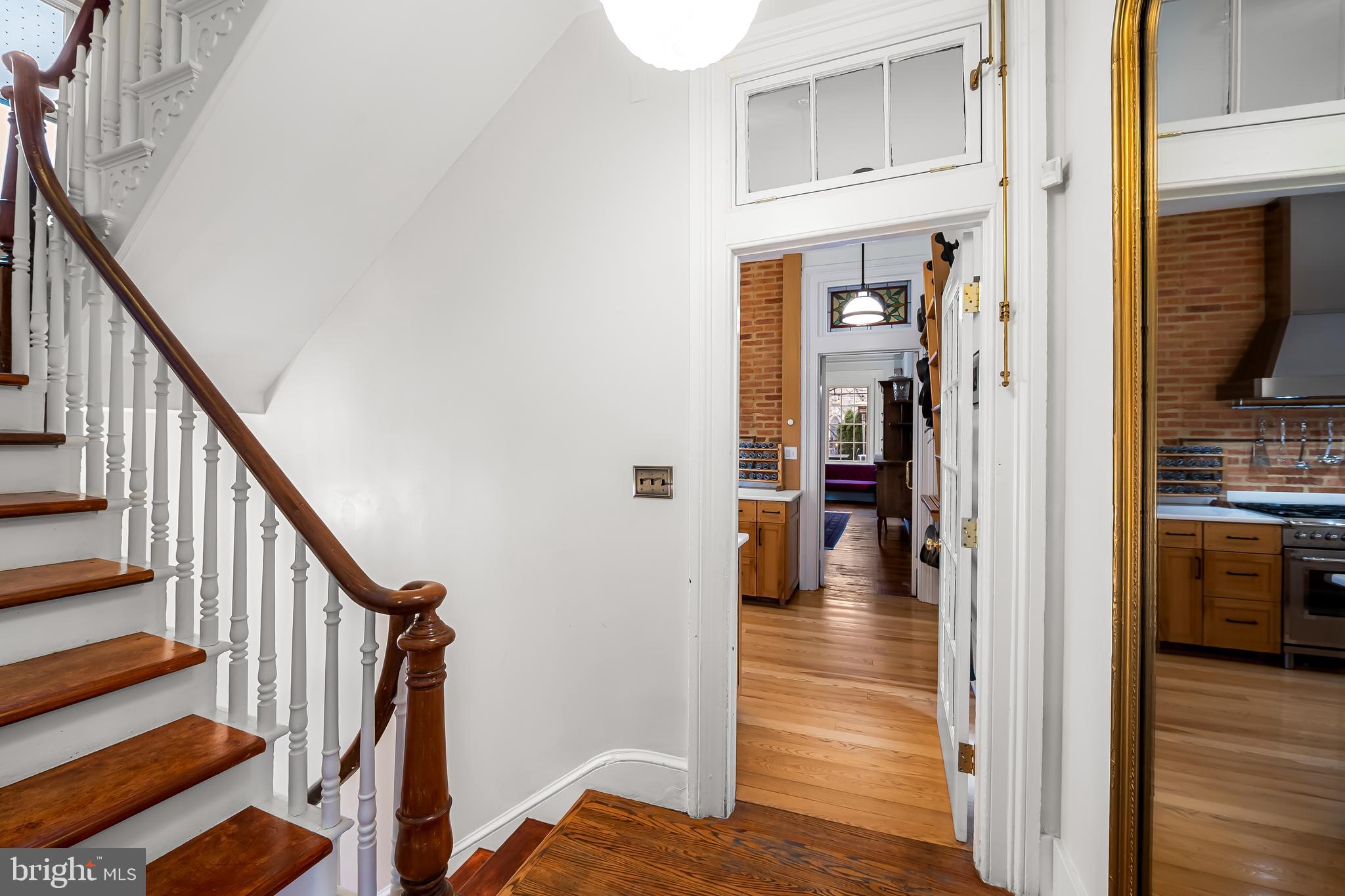16 West Read Street Baltimore, MD 21201 - Photo 14 of 59 a view of a hallway with wooden floor fireplace and living room