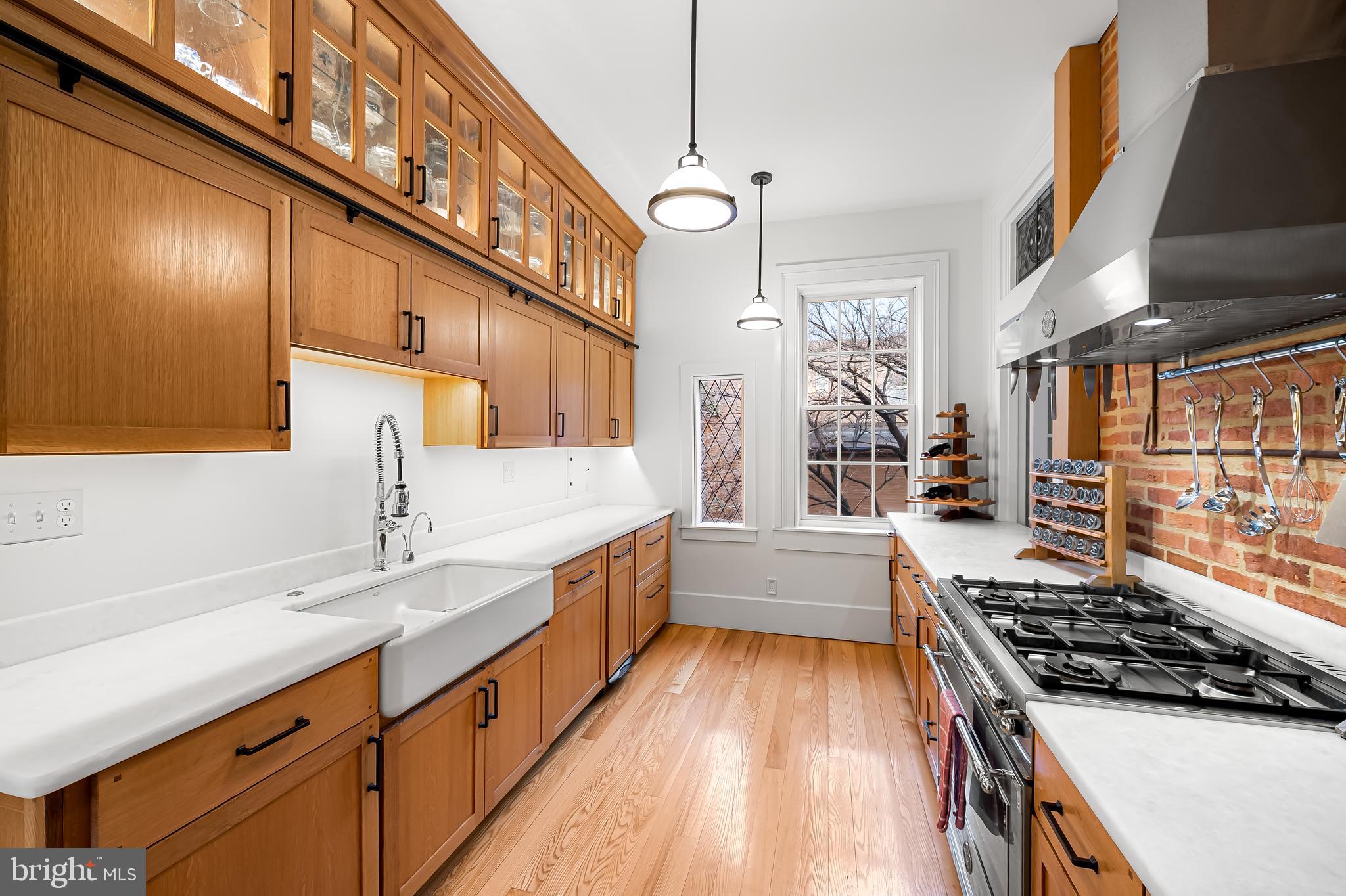 16 West Read Street Baltimore, MD 21201 - Photo 15 of 59 a large kitchen with stainless steel appliances granite countertop a lot of counter space and a sink