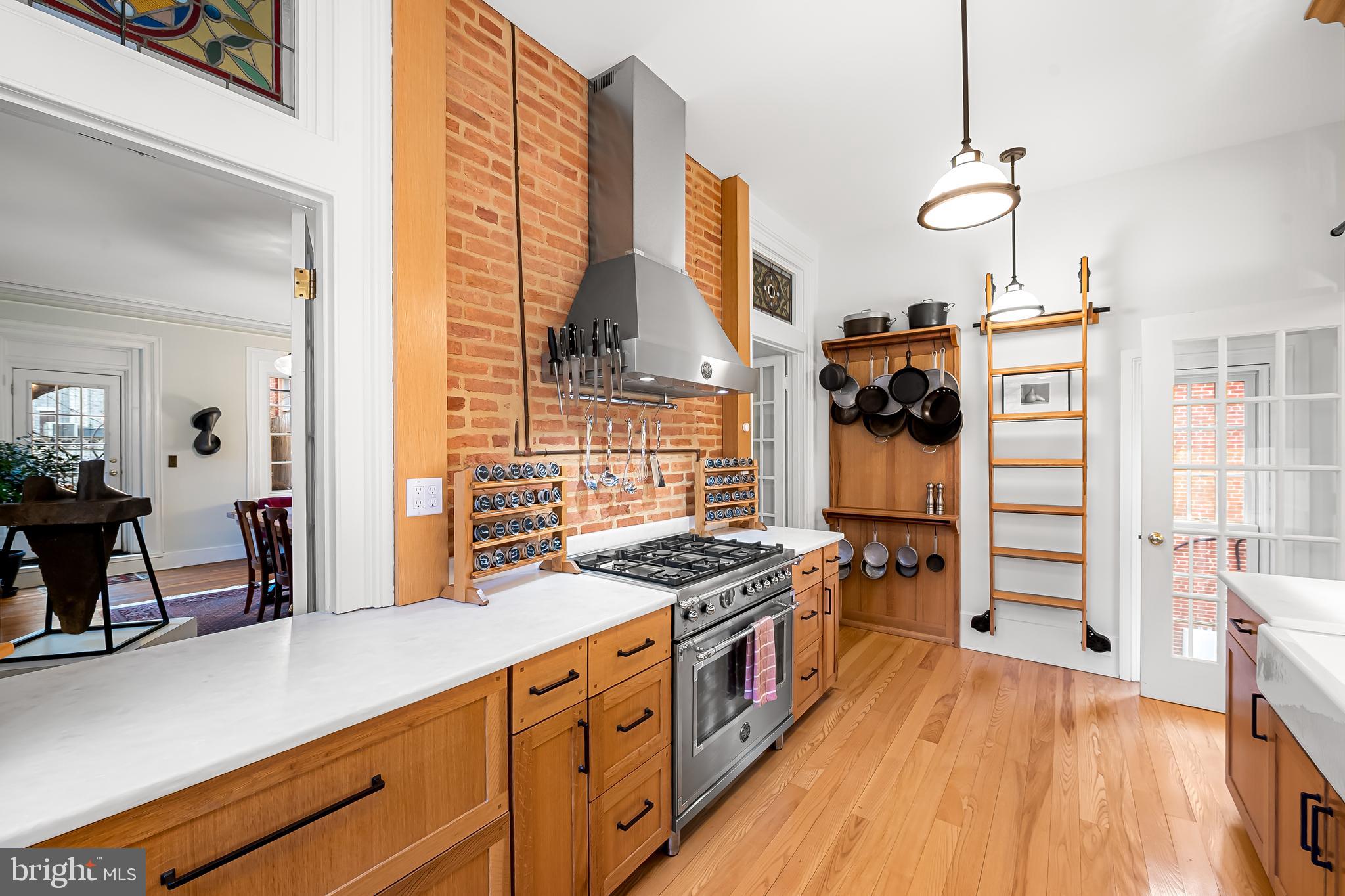 16 West Read Street Baltimore, MD 21201 - Photo 16 of 59 a kitchen with stainless steel appliances granite countertop a stove and a wooden floors