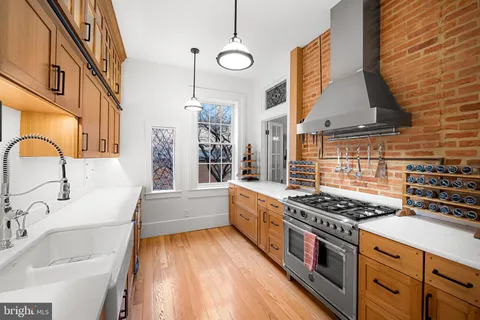 a kitchen with stainless steel appliances granite countertop a stove and a sink