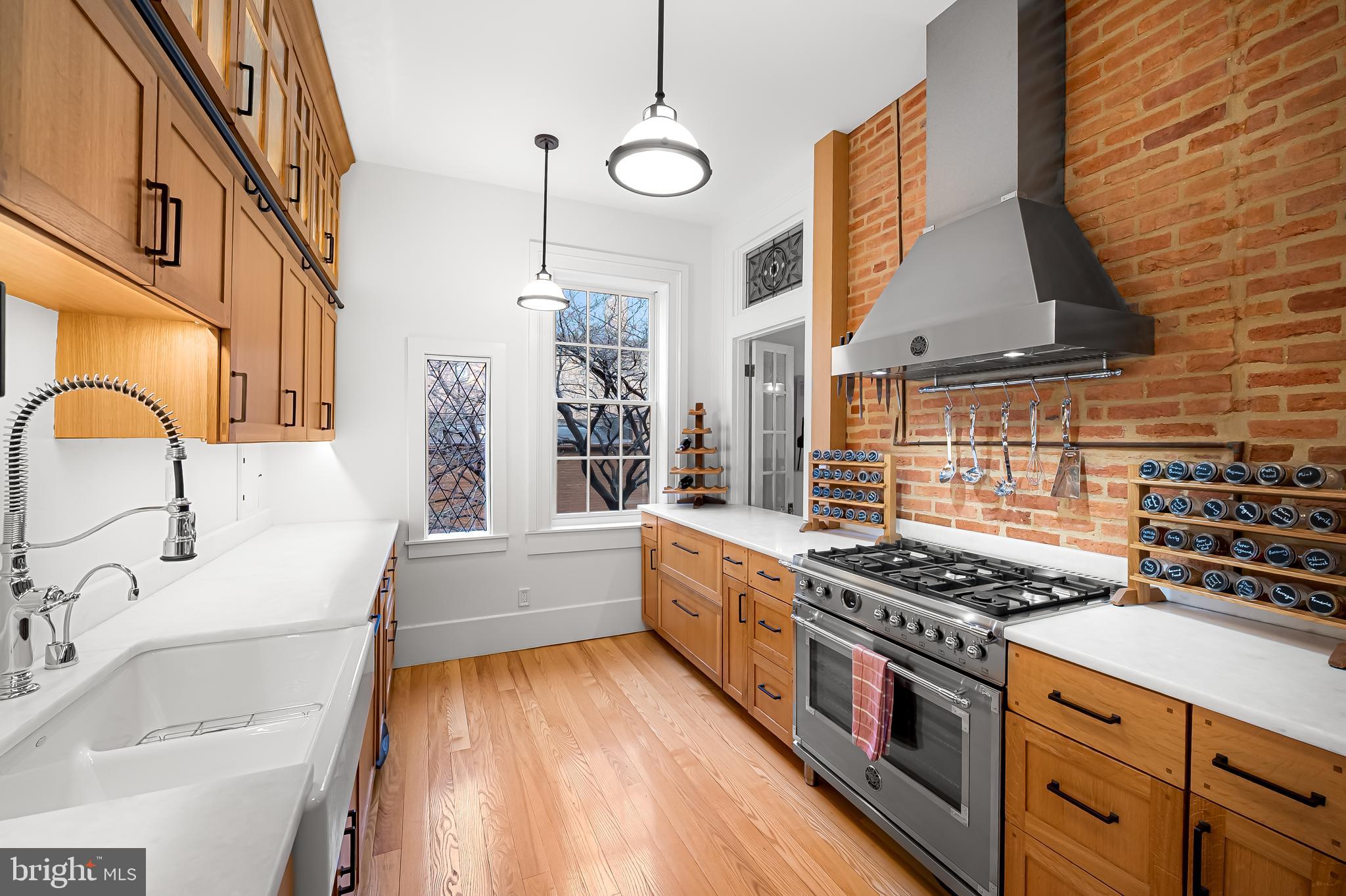 16 West Read Street Baltimore, MD 21201 - Photo 17 of 59 a kitchen with stainless steel appliances granite countertop a stove and a sink