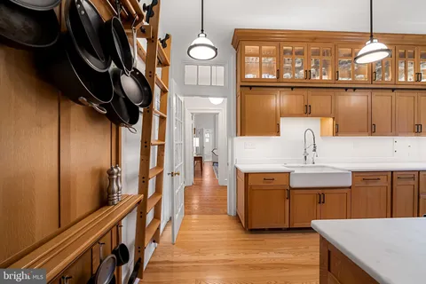 a kitchen with a sink stainless steel appliances cabinets and a counter top space
