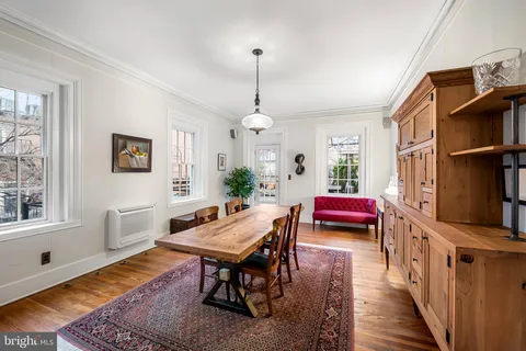 a living room with furniture a rug and a window