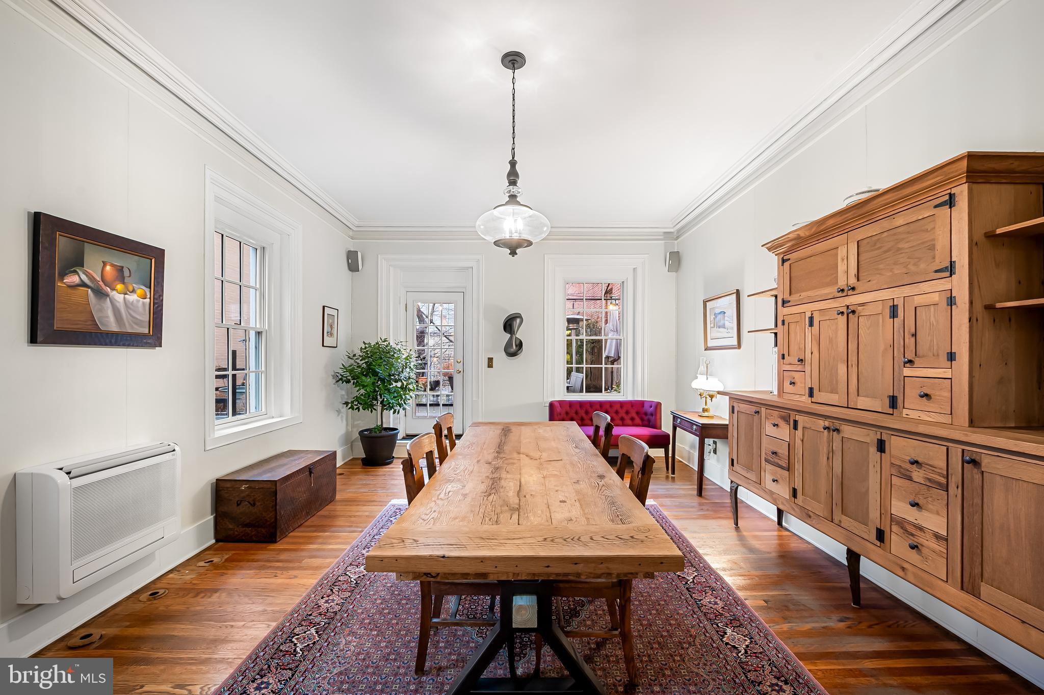 16 West Read Street Baltimore, MD 21201 - Photo 24 of 59 a living room with furniture a dining table and chairs with wooden floor