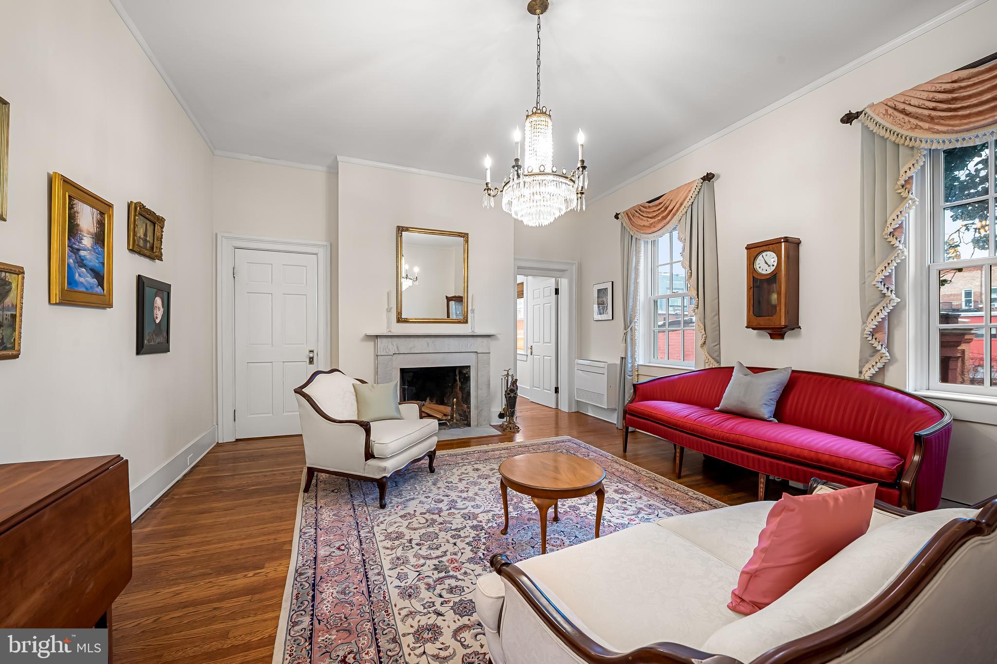 16 West Read Street Baltimore, MD 21201 - Photo 25 of 59 a living room with furniture a fireplace and a chandelier
