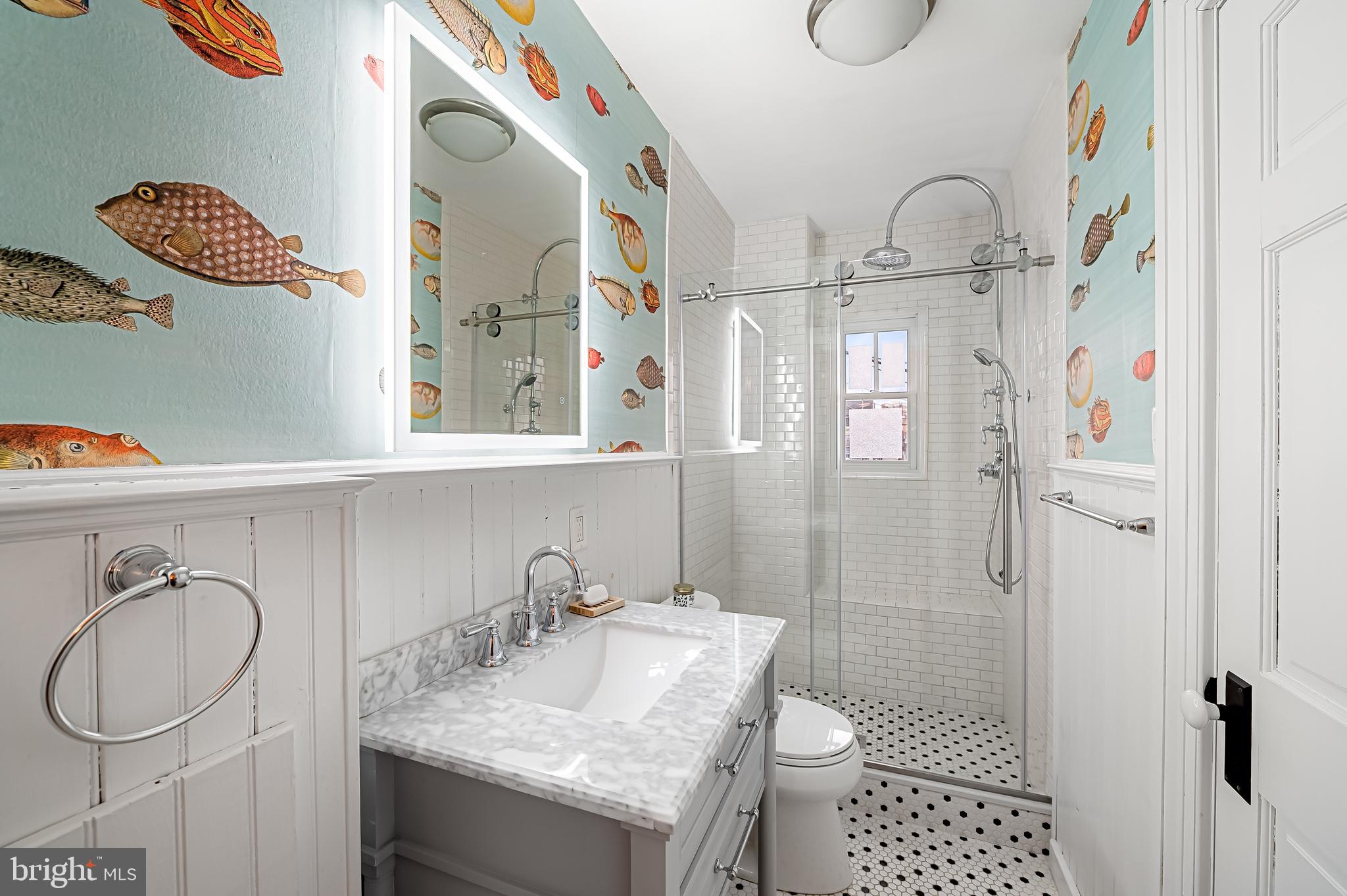 16 West Read Street Baltimore, MD 21201 - Photo 29 of 59 a bathroom with a granite countertop sink toilet and shower
