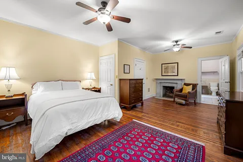 a spacious bedroom with a bed and a chandelier