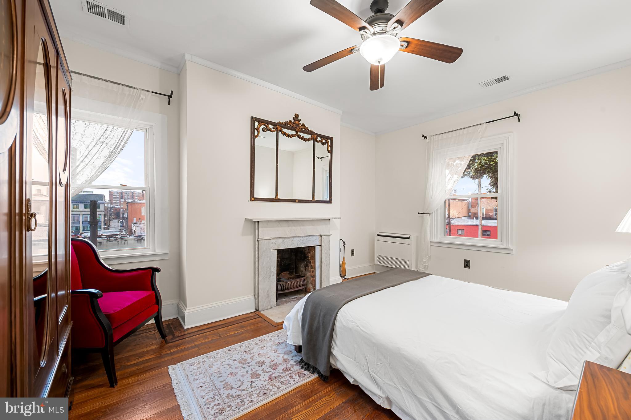 16 West Read Street Baltimore, MD 21201 - Photo 36 of 59 a bedroom with a bed and a chandelier