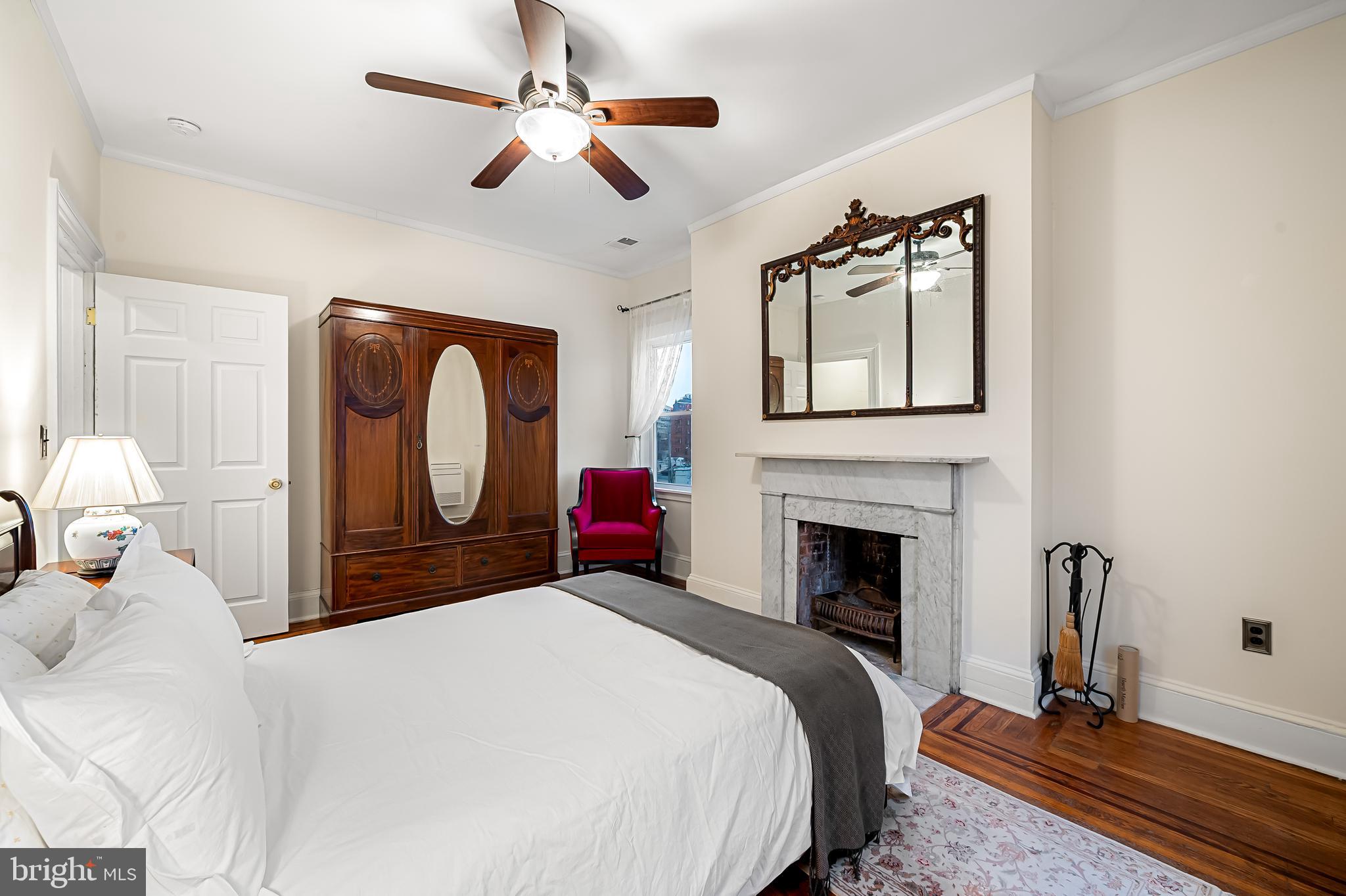 16 West Read Street Baltimore, MD 21201 - Photo 37 of 59 a bedroom with a bed dresser and a large mirror