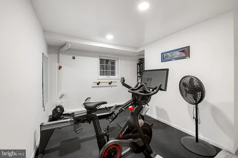 a view of a room with furniture a flat screen tv and a window