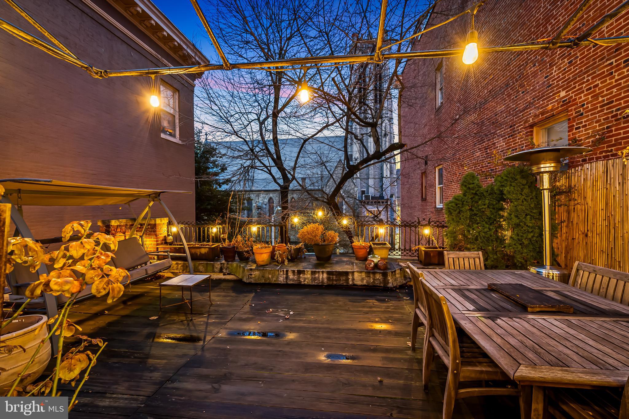 16 West Read Street Baltimore, MD 21201 - Photo 42 of 59 a view of a patio with table and chairs with wooden floor
