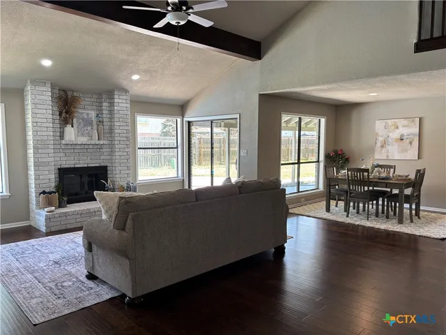 a living room with furniture wooden floor and a fireplace