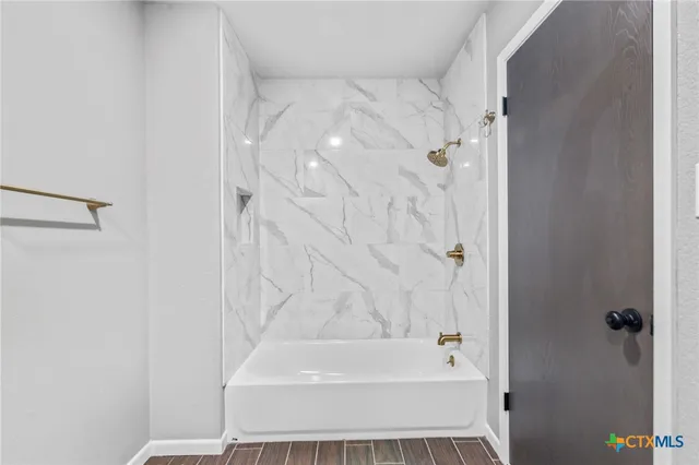 a bathroom with a bathtub and a shower