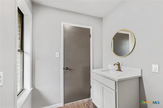 a bathroom with a sink and a mirror
