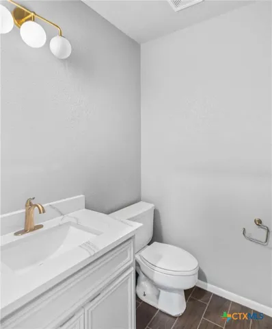 a white toilet sitting next to a bathroom sink