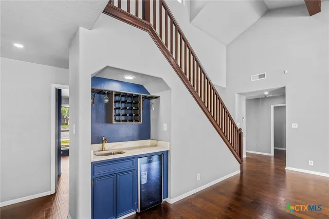 a view of hallway with wooden floor and staircase
