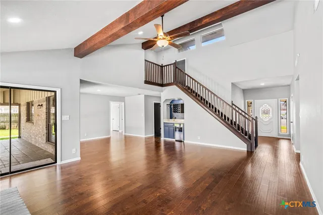 a view of entryway and hall with wooden floor