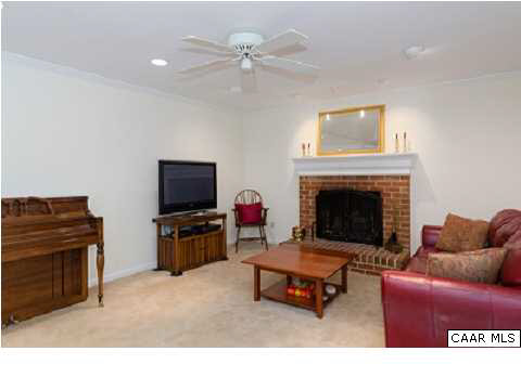 2551 Thrush Road Charlottesville, VA 22901 - Photo 8 of 17 a living room with furniture a flat screen tv and a fireplace