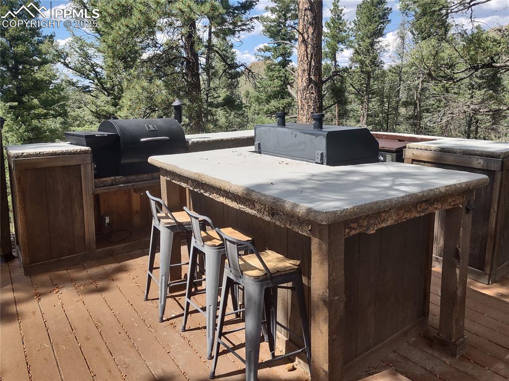 1176 Trail Creek Road Lake George, CO 80827 - Photo 22 of 48 a view of a dinning table and chairs in the patio