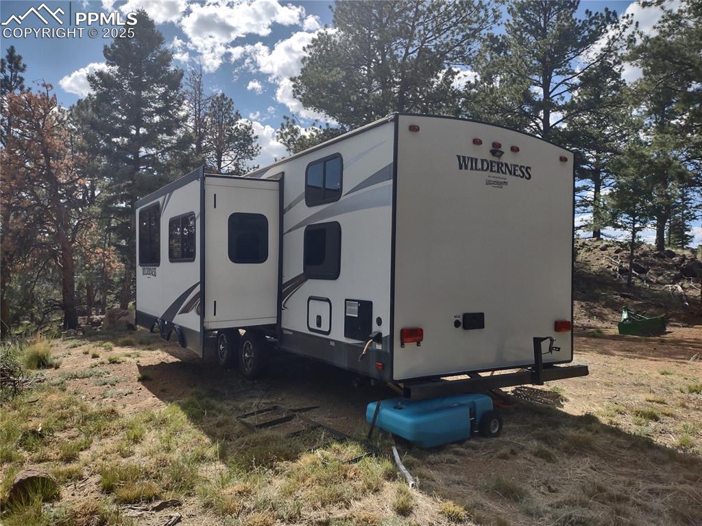 1176 Trail Creek Road Lake George, CO 80827 - Photo 38 of 48 a view of a white house with a large tree