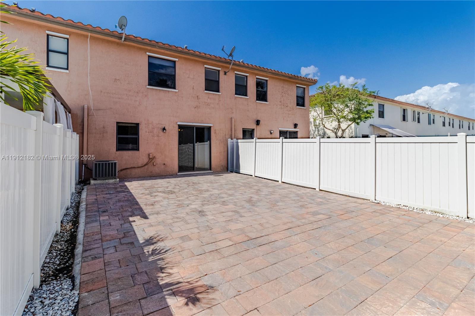 9045 West 33rd Avenue, Unit 9045 Hialeah, FL 33018 - Photo 11 of 23 a view of a white house with a yard