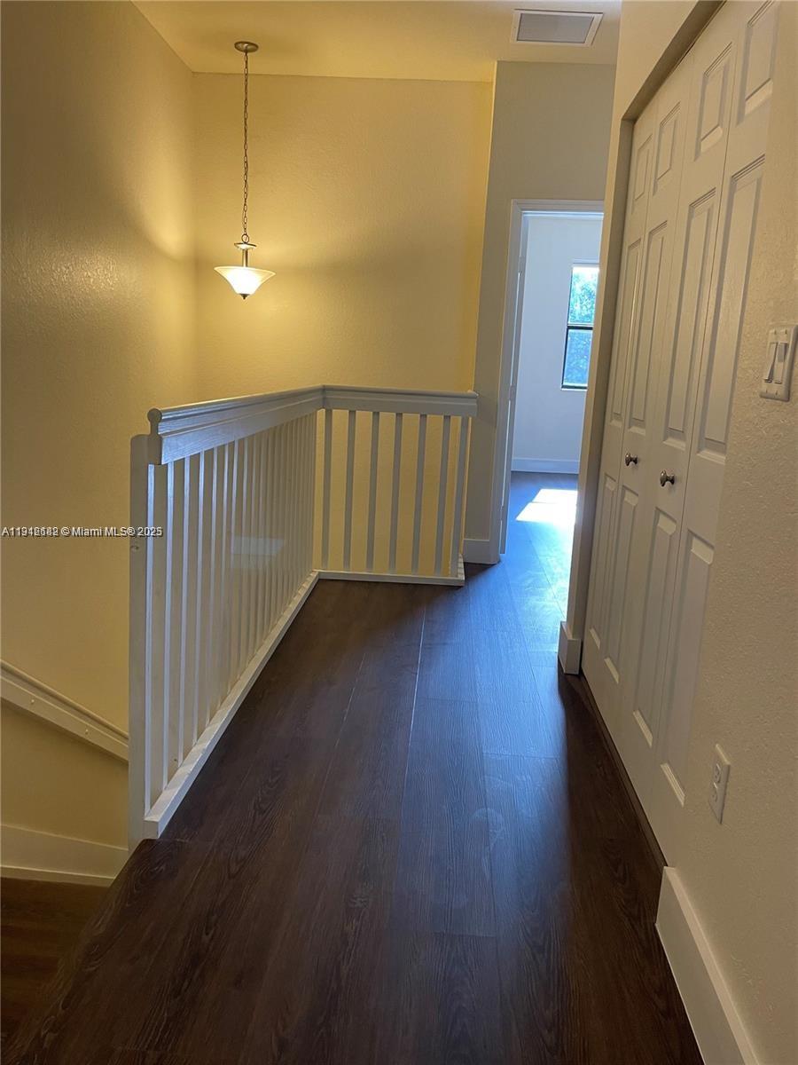9045 West 33rd Avenue, Unit 9045 Hialeah, FL 33018 - Photo 17 of 23 a view of a hallway with wooden floor