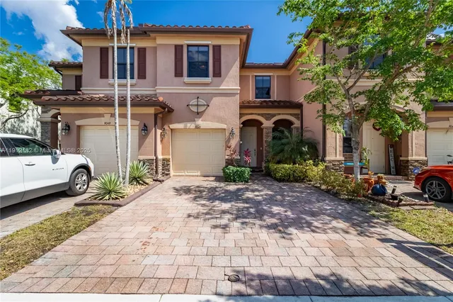 a view of a car park in front of a house