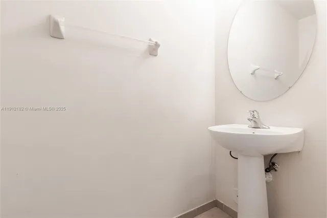 a bathroom with a sink and mirror