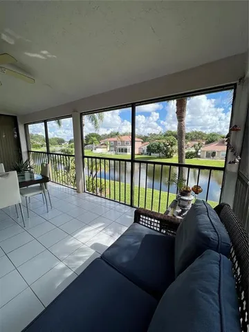 a bed sitting in a bedroom next to a large window