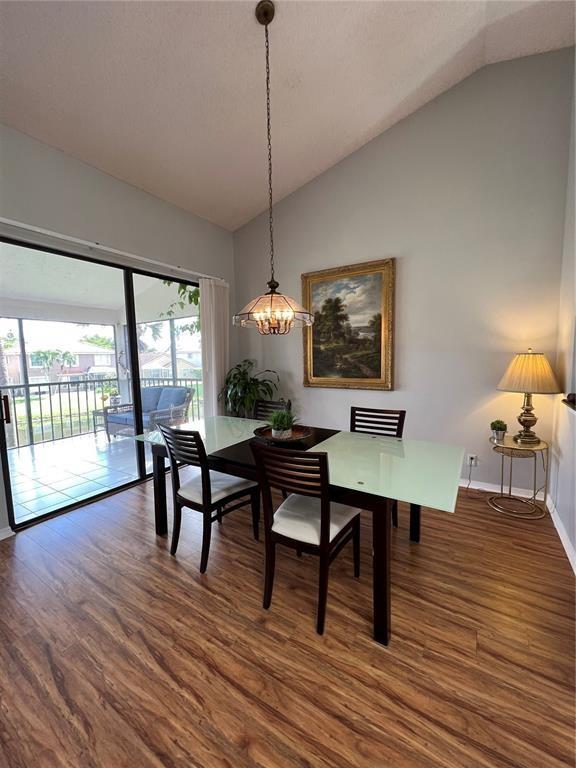 18266 Covina Way, Unit 202 Boca Raton, FL 33498 - Photo 13 of 52 a view of a dining room with furniture window and wooden floor