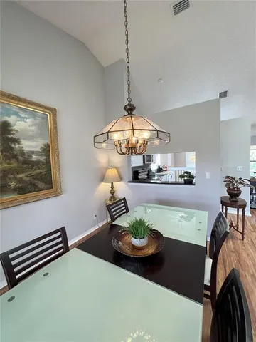 a kitchen with white cabinets and black appliances