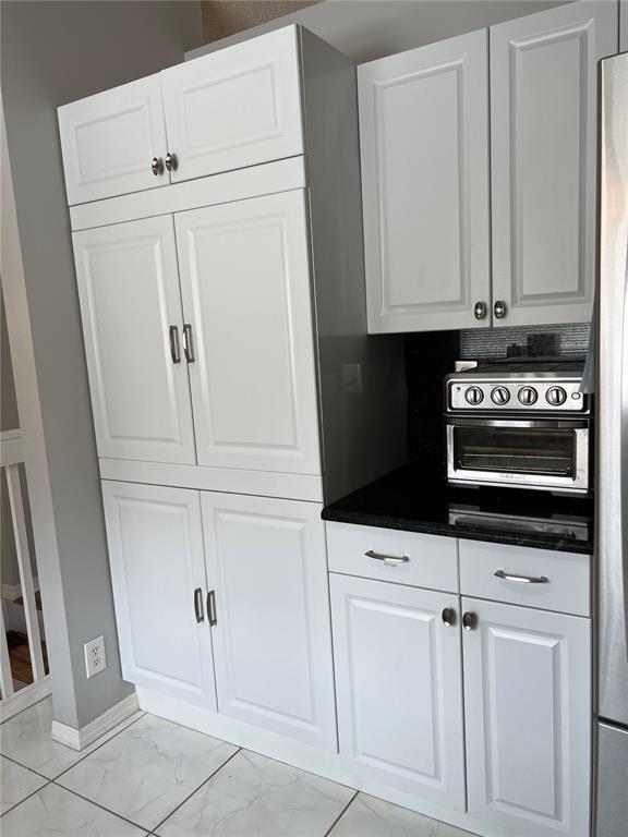 18266 Covina Way, Unit 202 Boca Raton, FL 33498 - Photo 18 of 52 a kitchen with white cabinets and white appliances