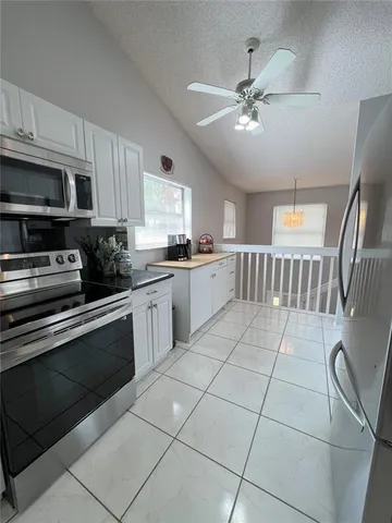 a living room with a dining table wooden floor and a fireplace