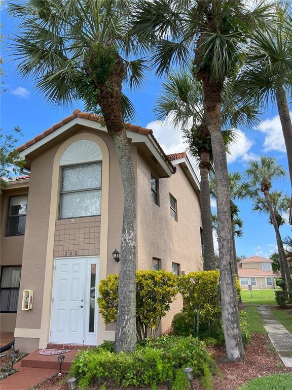 18266 Covina Way, Unit 202 Boca Raton, FL 33498 - Photo 2 of 52 a front view of a house with balcony