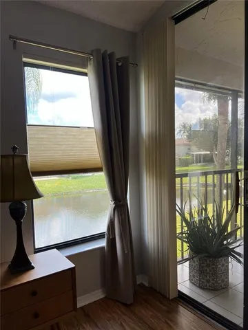 a room with pool table and windows