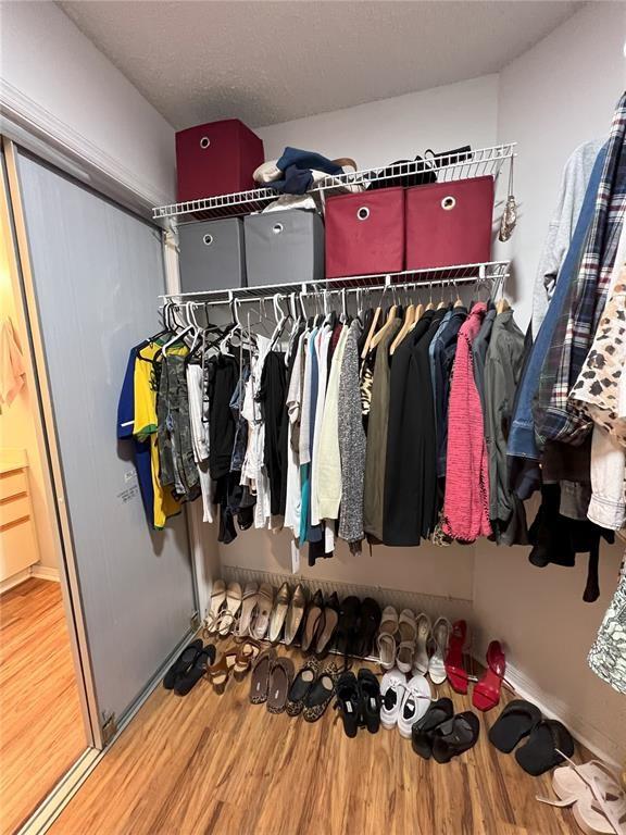 18266 Covina Way, Unit 202 Boca Raton, FL 33498 - Photo 30 of 52 a view of walk in closet with clothes and shoes