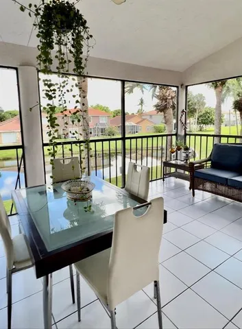 a view of a living room and floor to ceiling window or wooden floor