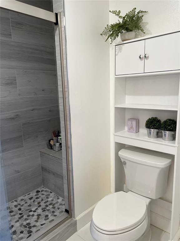 18266 Covina Way, Unit 202 Boca Raton, FL 33498 - Photo 32 of 52 a bathroom with a toilet and a shower
