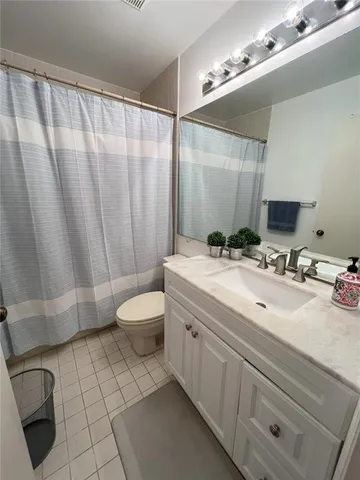 a bathroom with a double vanity sink toilet mirror and bathtub