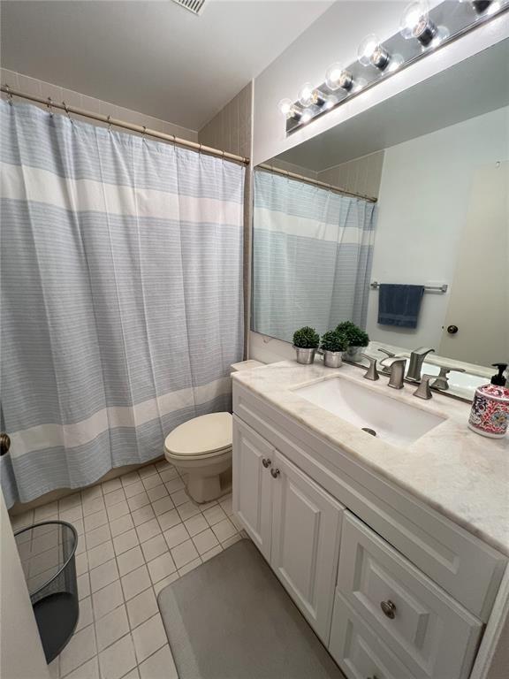 18266 Covina Way, Unit 202 Boca Raton, FL 33498 - Photo 37 of 52 a bathroom with a sink a toilet and shower