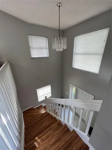 a view of staircase with white walls and windows
