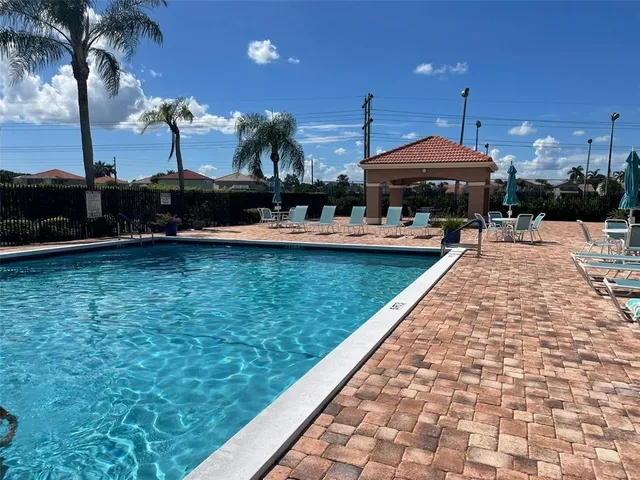 a view of a swimming pool with seating area