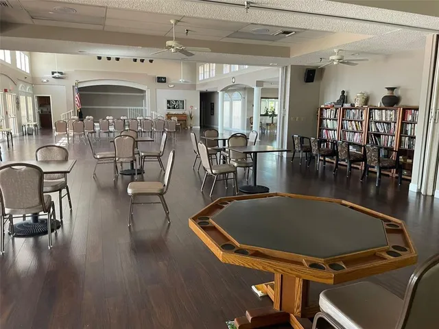 a room with pool table and windows