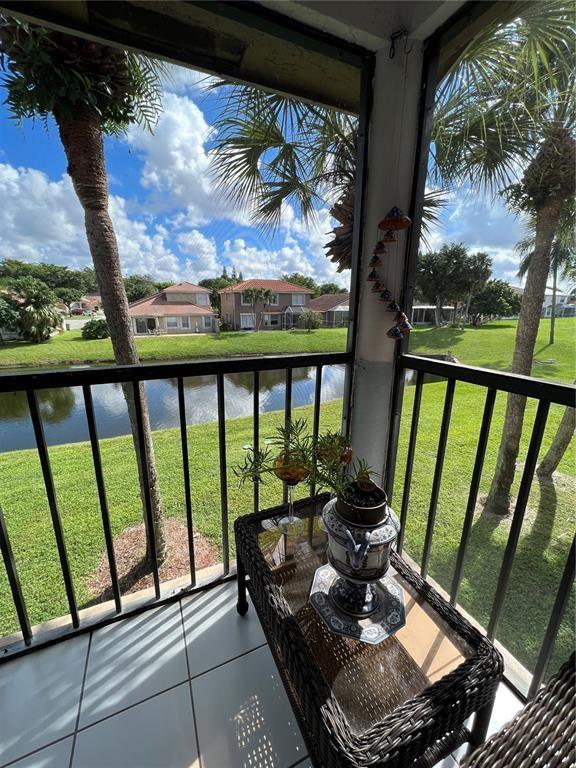 18266 Covina Way, Unit 202 Boca Raton, FL 33498 - Photo 6 of 52 a view of a balcony with chairs and a table