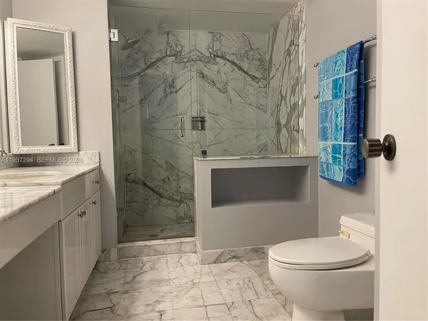 a bathroom with a toilet and a shower
