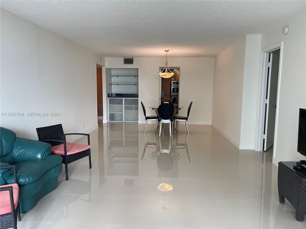 a dining room with furniture and a kitchen view