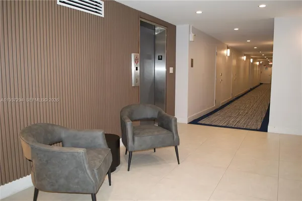 a hallway with a couch and mirror