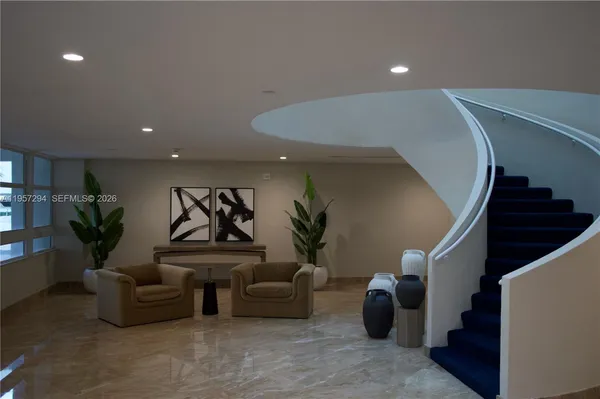 a living room with furniture and stairs