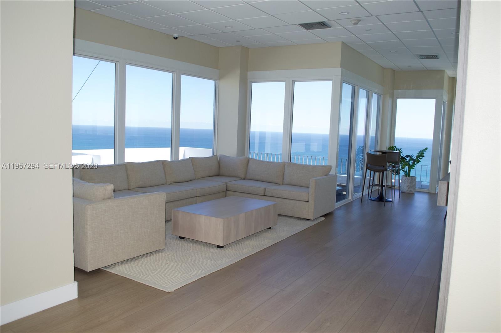 1370 South Ocean Boulevard, Unit 903 Pompano Beach, FL 33062 - Photo 31 of 34 a living room with couches and a large window