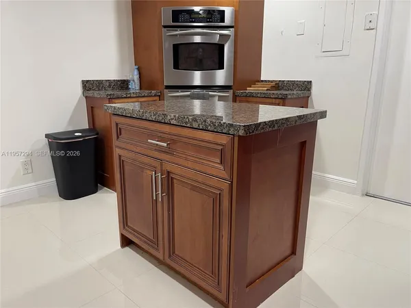 a kitchen with stainless steel appliances granite countertop a sink stove and microwave